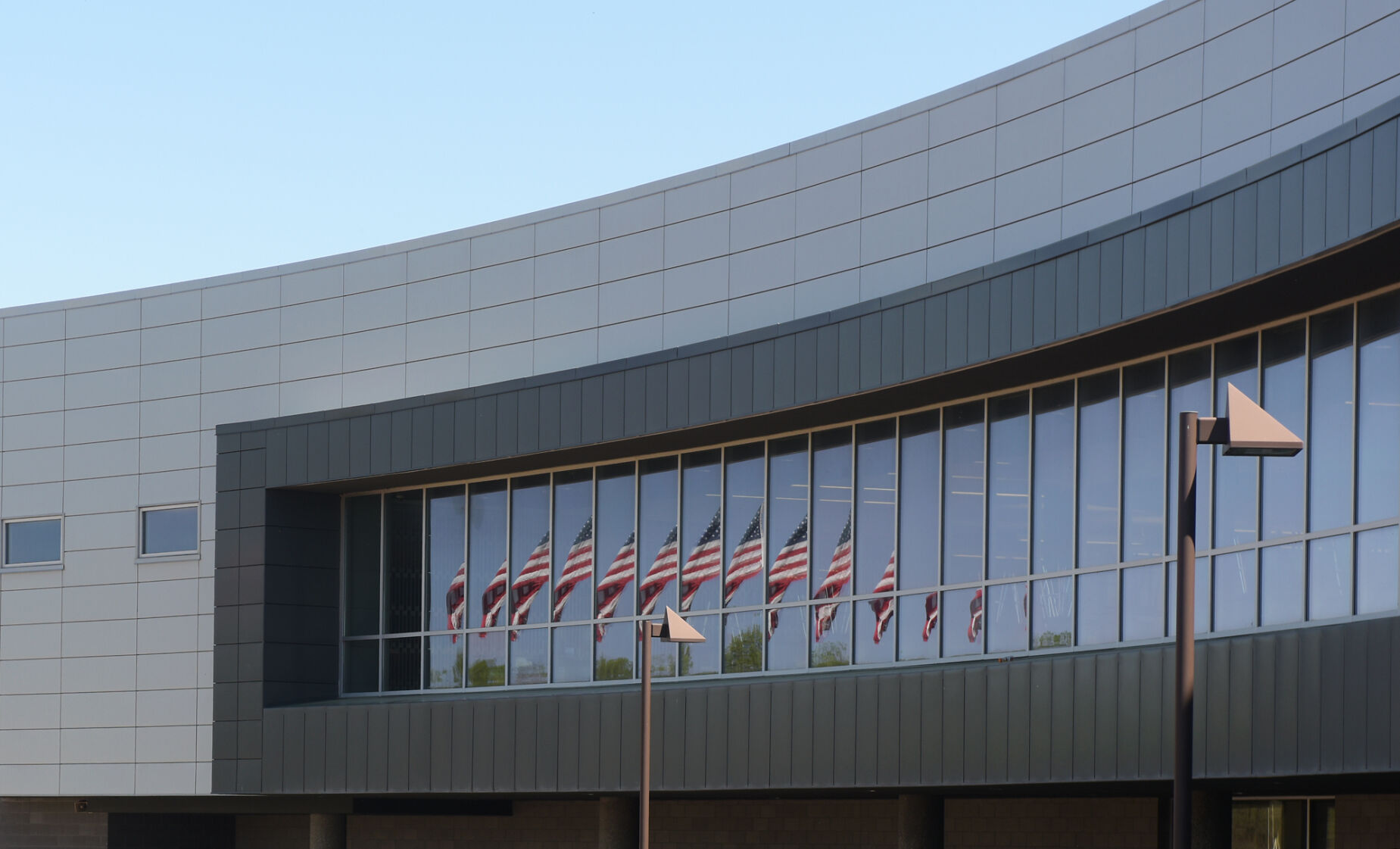 The American Flag reflects off Battle High School's windows